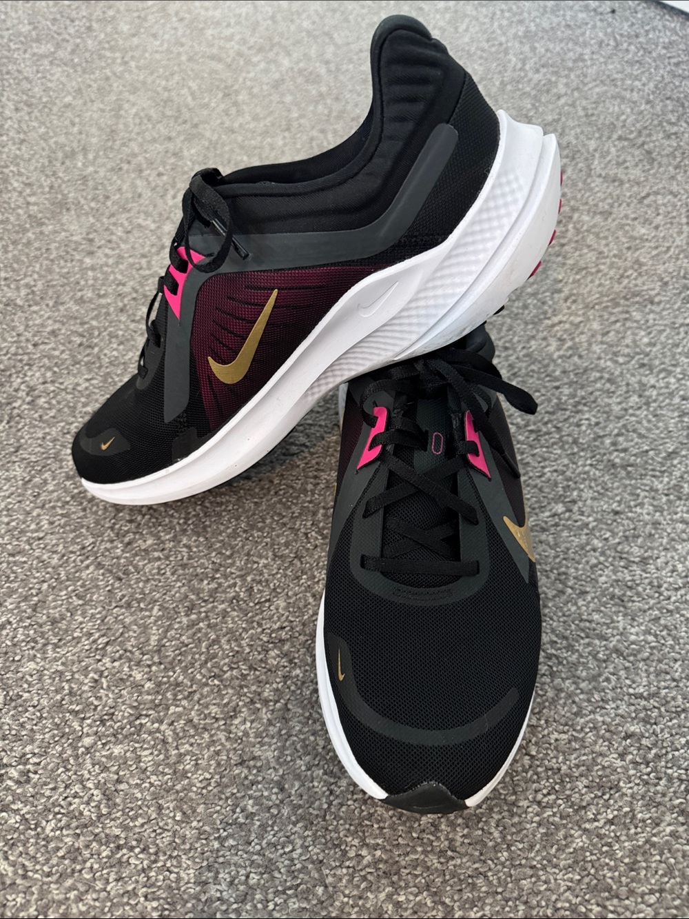 Nike Women’s Black Shoes with Gold Swoosh and Pink Accents